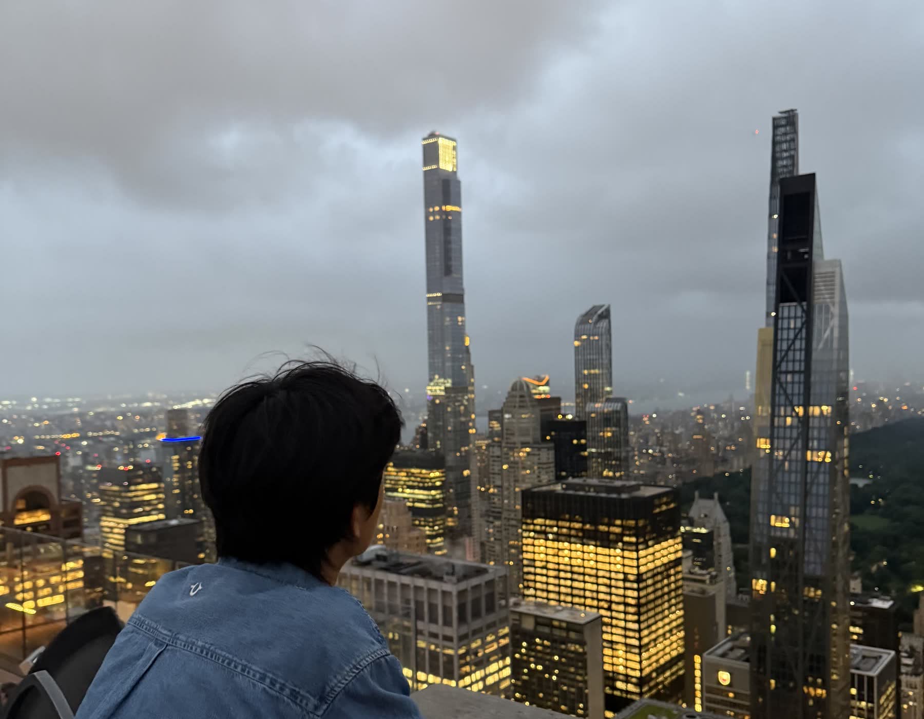 _junick looking out over the Manhattan skyline at dusk